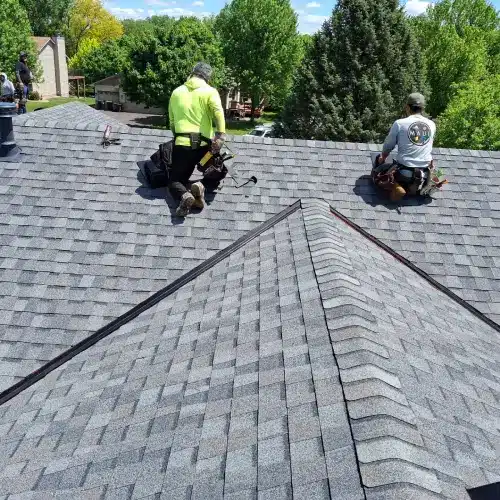 Roofing contractors installing new asphalt shingles on Minnesota home by Wright at Home Roofing & Exteriors in Minnesota
