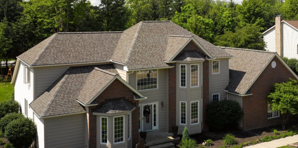 House with brown roof and white siding that had house siding colors simulator by Wright At Home Roofing & Exteriors in Minneapolis, MN