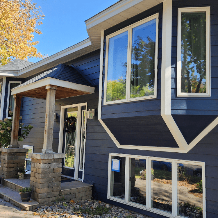 Suburban home featuring dark blue or gray James Hardie lap siding installed by siding contractors in Minneapolis, MN