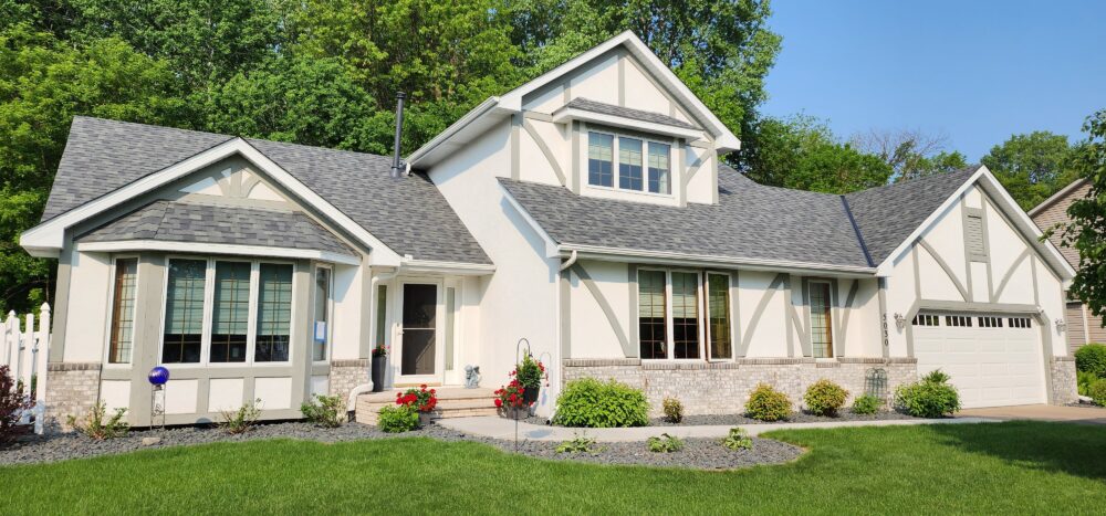 House with multiple gables and a bay window, black roof and white siding by Wright at Home Roofing & Exteriors in Minneapolis, MN