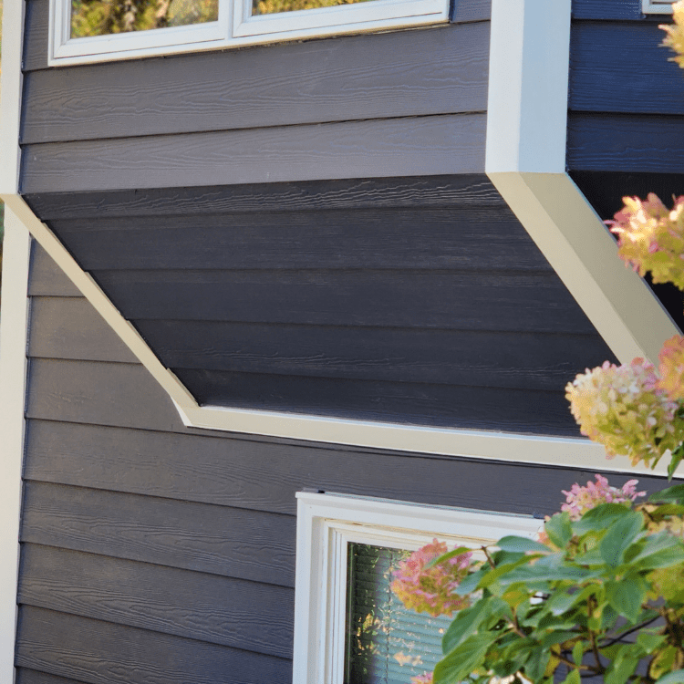 Suburban home featuring dark blue or gray James Hardie lap siding installed by siding contractors in Minneapolis, MN