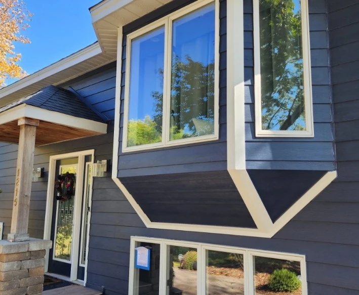 House with dark blue horizontal siding made by siding replacement contractor in Minneapolis, MN