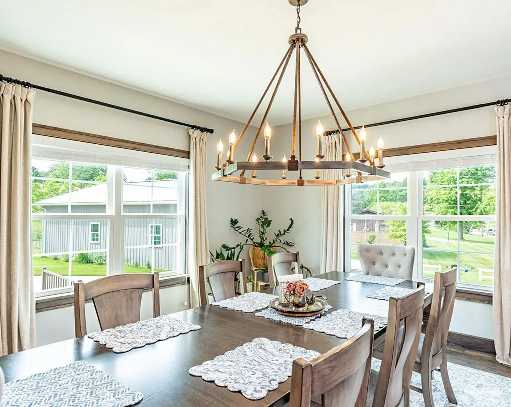 A dining room with a large wooden table and six chairs with Marbin Windows in Minneapolis, MN