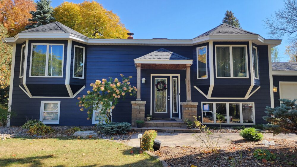 Exterior view of a residential home featuring dark-colored siding installed by siding contractors in Minneapolis, MN