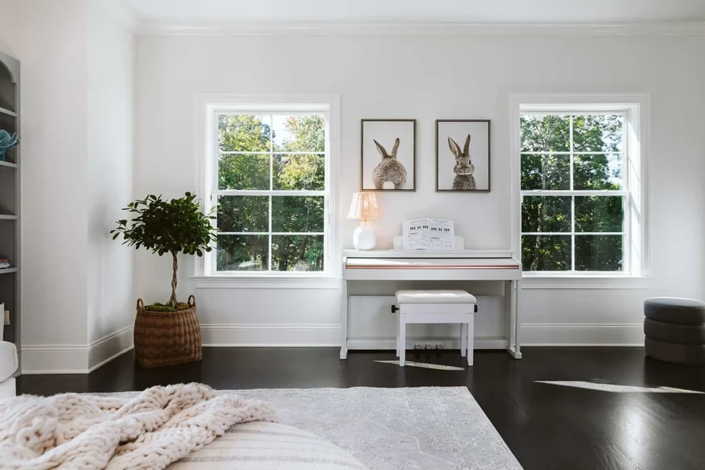 A room with white walls, dark wood floors, and two marvin windows in Minneapolos, MN