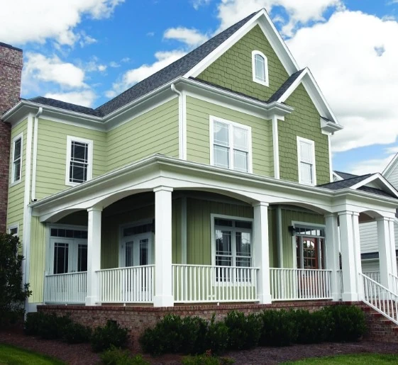 House with light green horizontal siding and a darker green roof by siding contractor in Minneapolis, MN