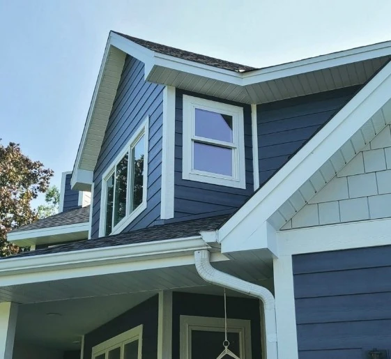 House with black roof and blue siding in Minneapolis, MN