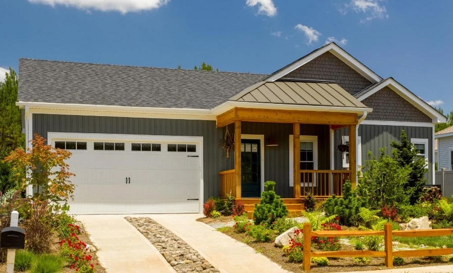 Modern-style house with dark gray vertical siding and a light gray roof installed by Wright at Home Roofing & Exteriors residential roofing contractor in Minneapolis