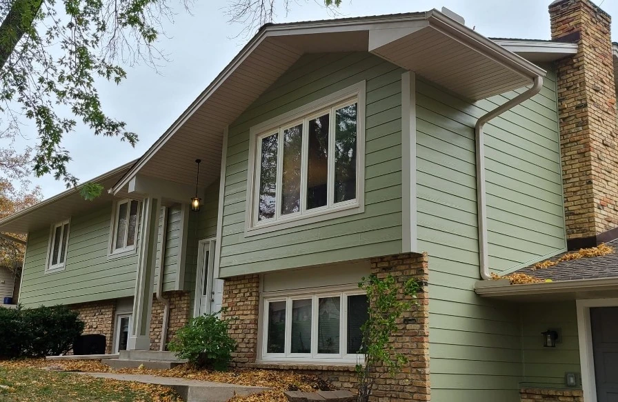 House with James Hardie siding and brick siding and several windows made by a siding contractor in Minneapolis, MN