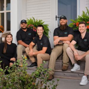 Wright at Home Roofing & Exteriors staff sitting infront of a house in Minneapolis, MN