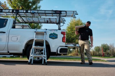 Wright at Home Roofing & Exteriors staff carrying sidings on the company truck in Minneapolis, MN