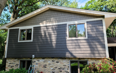 House with black roof and grey siding by roofing and siding contractors in Minneapolis, MN