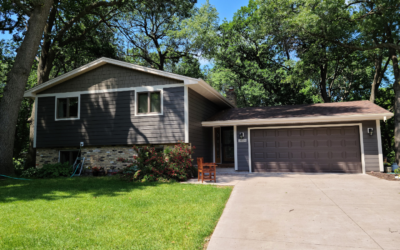 House with black roof and grey siding by roofing and siding contractors in Minneapolis, MN