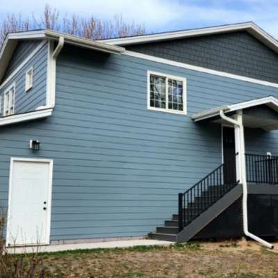 Two-story house with light blue siding, white trim by siding contractor in Minneapolis, MN