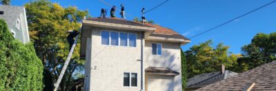 Wright at Home Roofing & Exteriors crew on top of a roof in a process of roof replacement in Minneapolis, MN