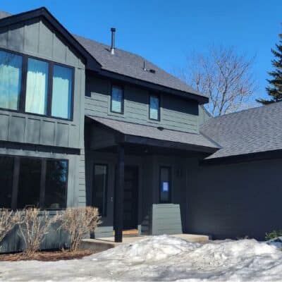 two-story house with dark gray siding, black trim, and a gray roof in Minneapolis, MN