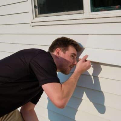 Wright at Home Roofing & Exteriors siding contractor in the process of siding replacement inspection in Minneapolis, MN
