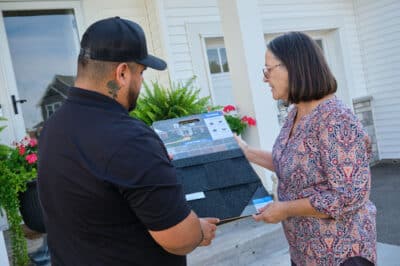 Homeowner discussing roofing insurance coverage with an agent