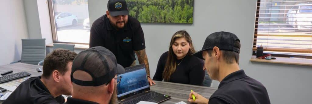 Team collaboration meeting at Wright at Home Roofing & Exteriors in Minneapolis, MN during off-season planning