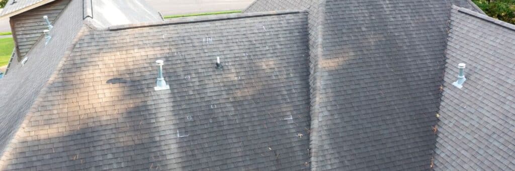 Aerial view of residential shingle roof showing widespread discoloration, indicating what storm damage looks like on a roof, by Wright at Home Roofing & Exteriors in Minneapolis