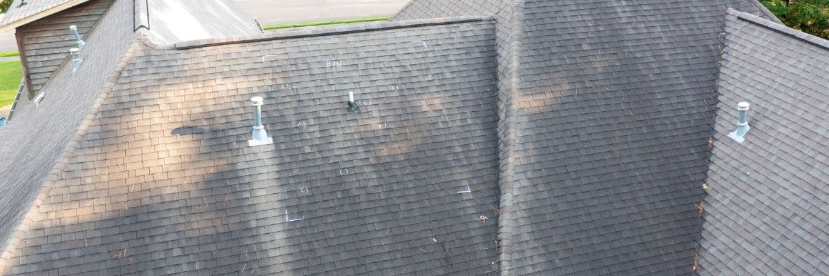 Aerial view of residential shingle roof showing widespread discoloration, indicating what storm damage looks like on a roof, by Wright at Home Roofing & Exteriors in Minneapolis