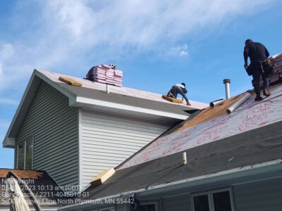 Crew installing underlayment and preparing shingle roof replacement by Wright at Home Roofing & Exteriors in Maple Grove