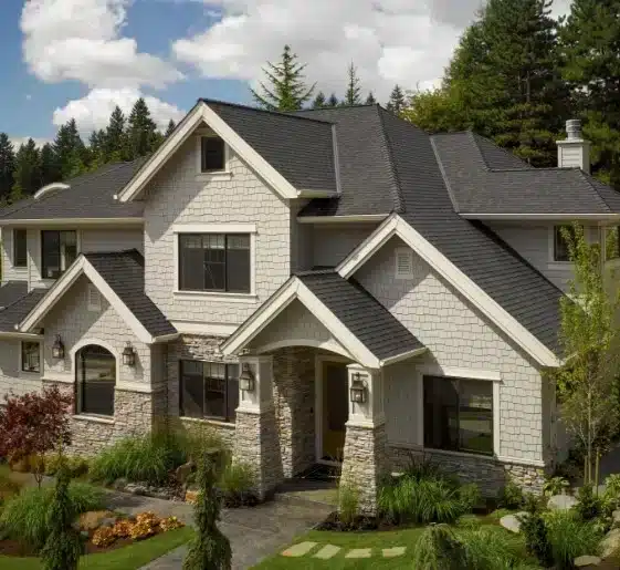 House with light gray shake siding, a dark gray roof by Wright at Home Roofing & Exteriors in Minneapolis, MN