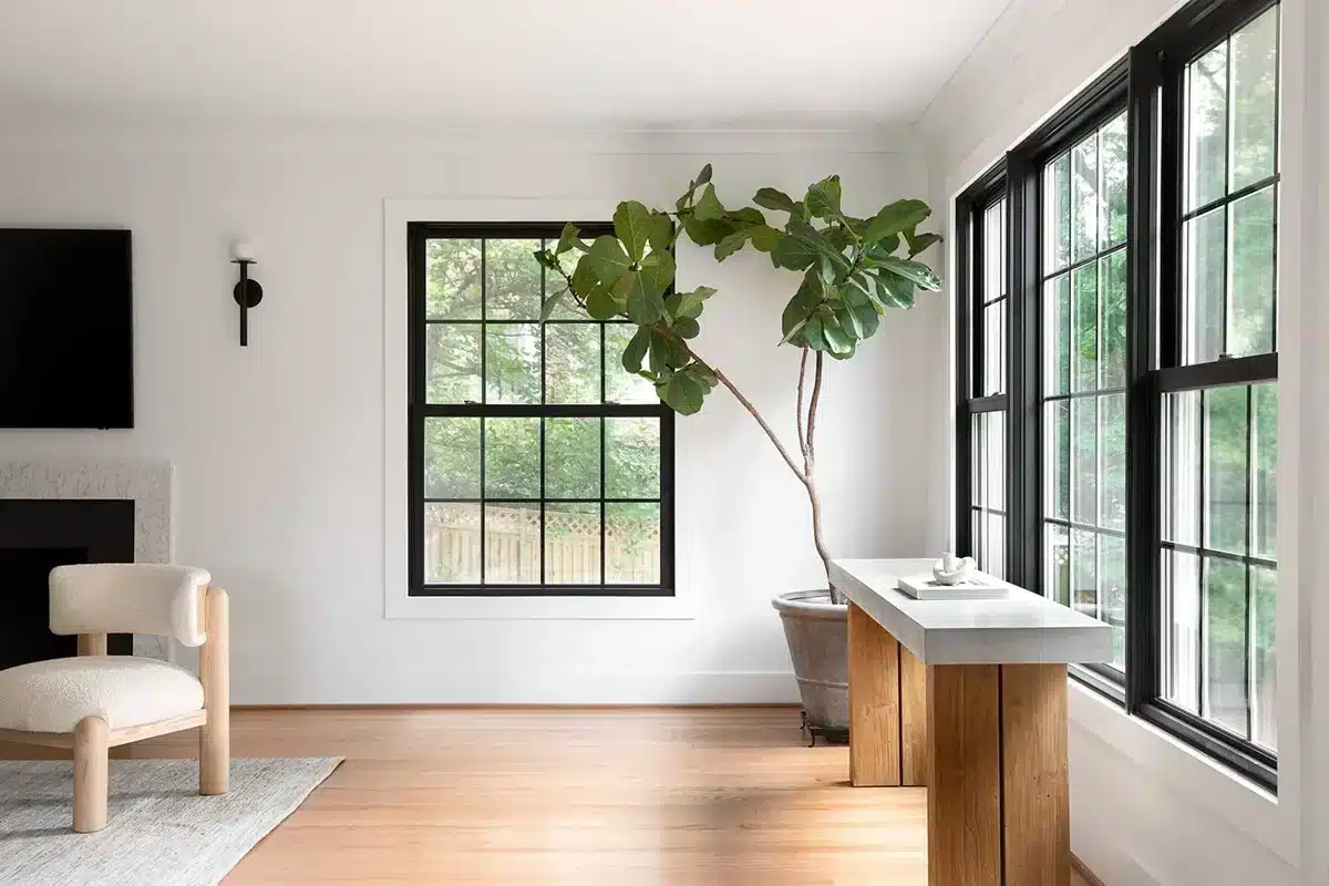 Modern living room with white walls, light wood floors, and black-framed Marvin windows in Minneapolis, MN