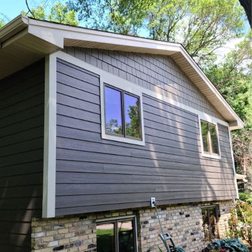 House with newly installed siding, roof, and windows by a siding replacement contractor in Minneapolis, MN