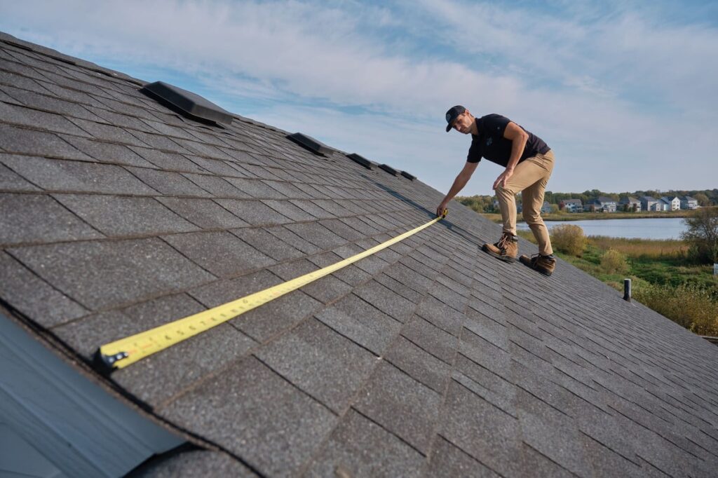 Contractor inspecting roof for insurance replacement approval