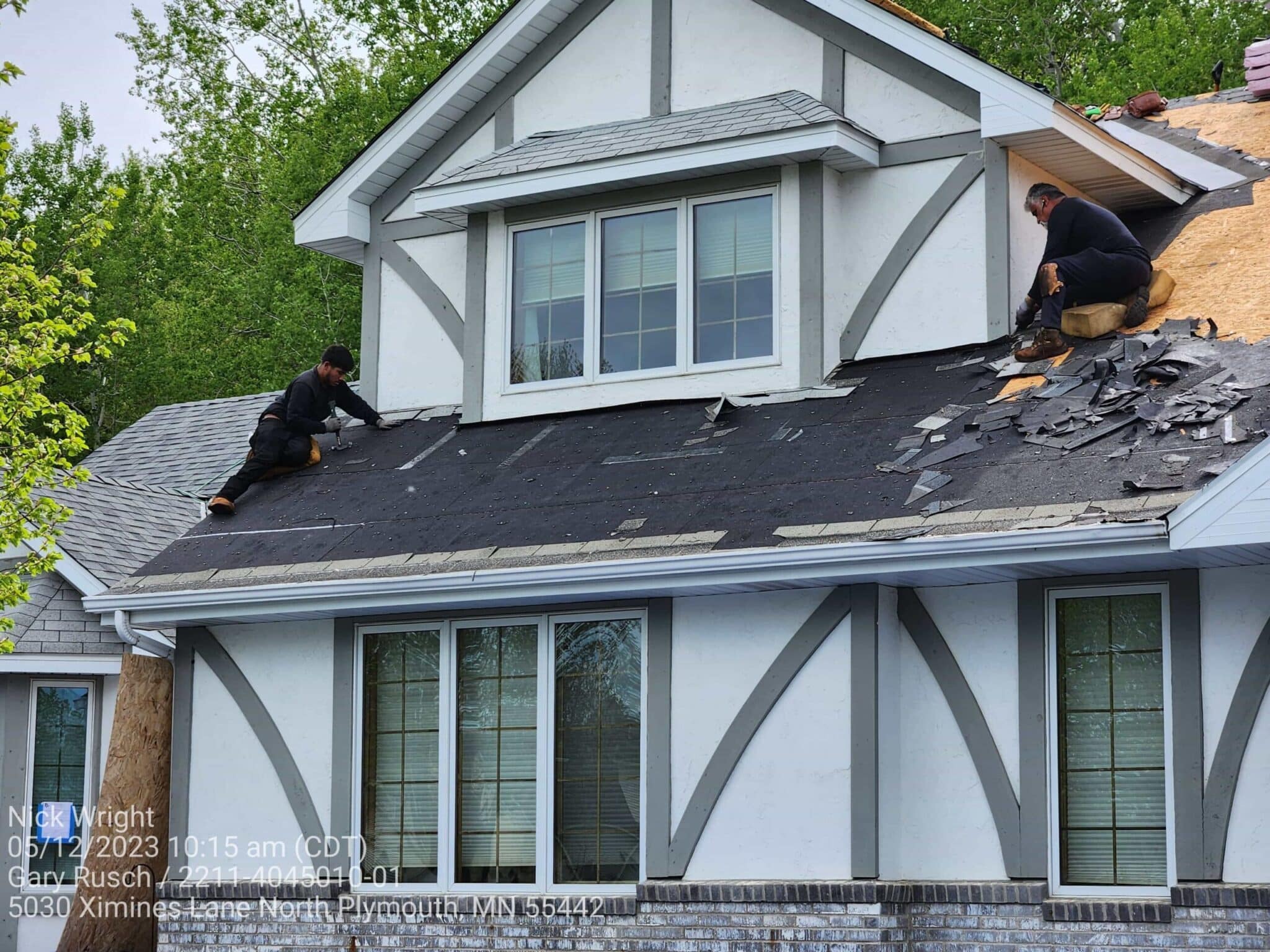 Crew removing old shingles and preparing new installation for shingle roof replacement in Maple Grove by Wright at Home Roofing & Exteriors
