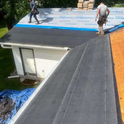 Roofing contractors properly install underlayment for ice and water shield on a residential roof in Minneapolis by Wright at Home Roofing & Exteriors