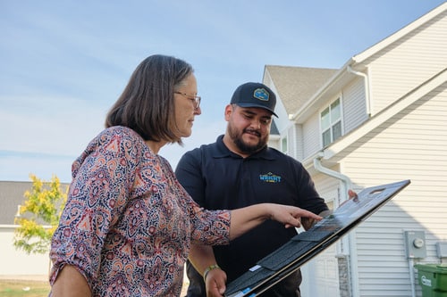 Insurance adjuster evaluating roof damage for an insurance claim payout
