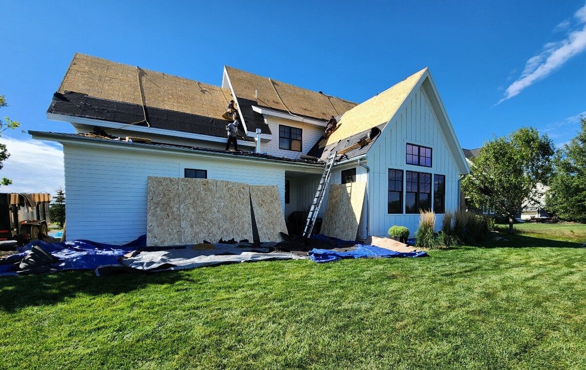 Roofing professionals installing Timberline HDZ shingles for a durable roof replacement.