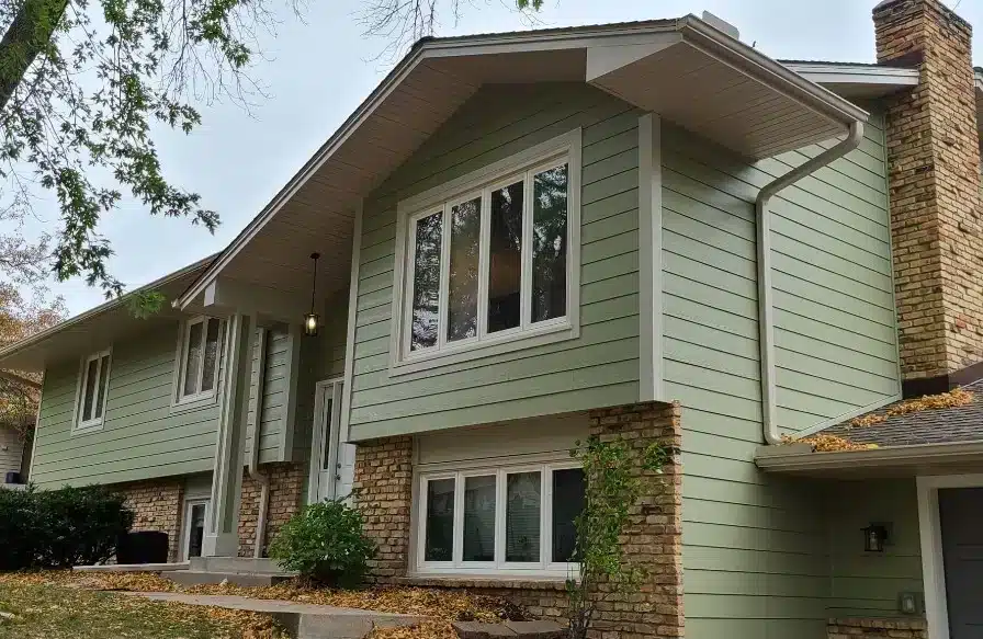 House with James Hardie siding and brick siding and several windows made by a siding contractor in Minneapolis, MN