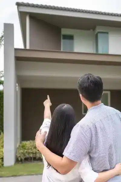 two homeowners look over potential roof damage that may require an insurance claim