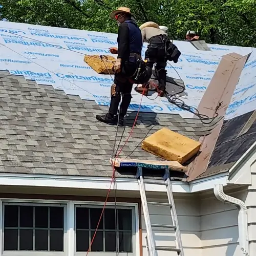 Roofing contractor Minnesota working on residential roof installation in Minneapolis, MN, with synthetic underlayment and shingles by Wright at Home Roofing & Exteriors