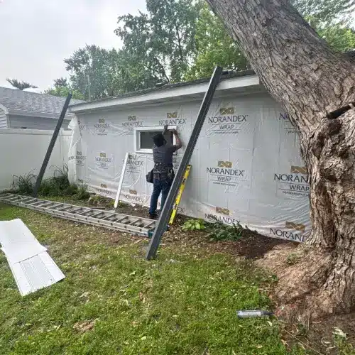 Contractor installing after siding on a residential home exterior in St. Louis Park, MN
