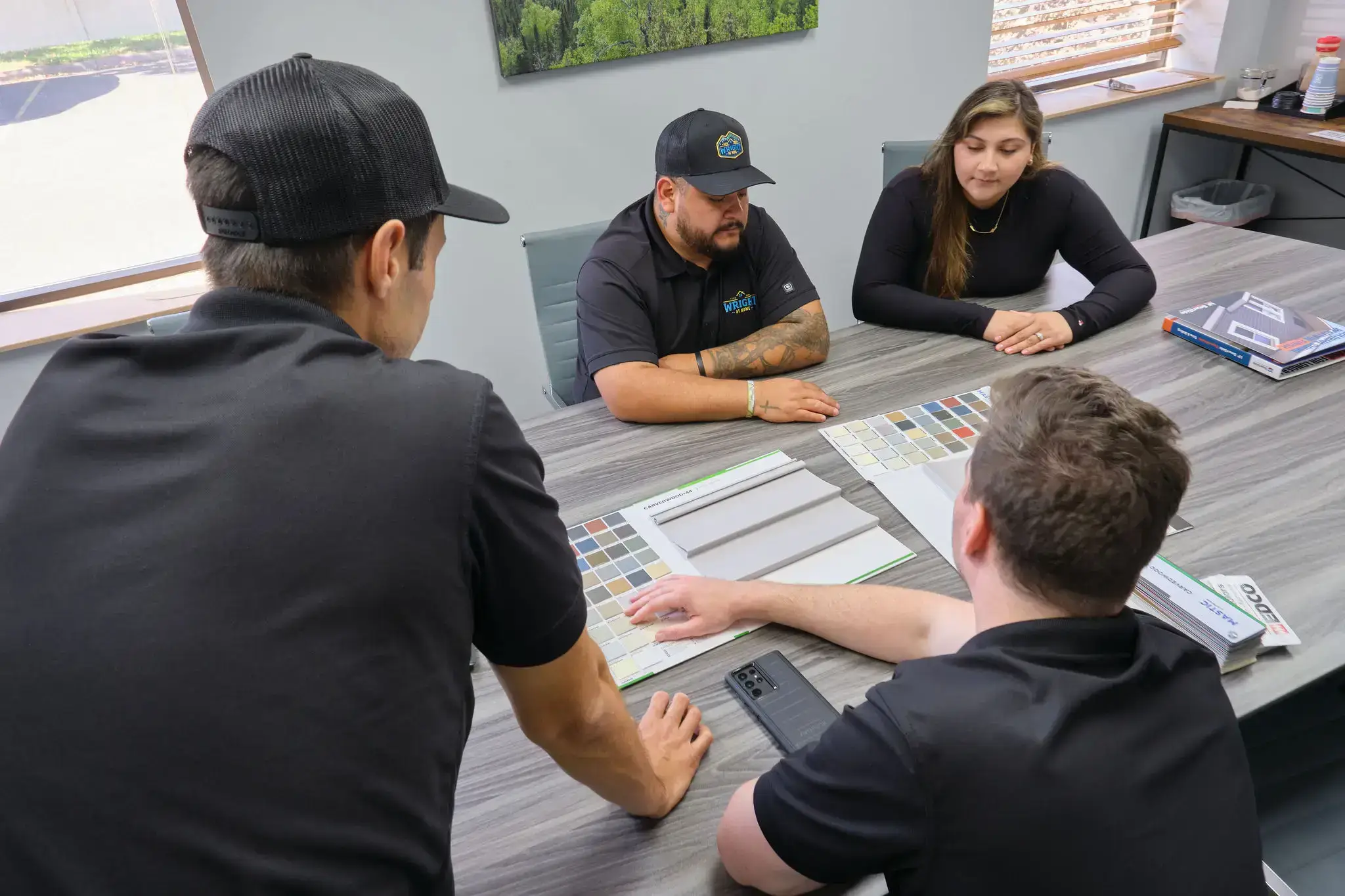 Wright at Home Roofing team discussing roofing and exterior color samples with clients for referral rewards in Minneapolis, MN