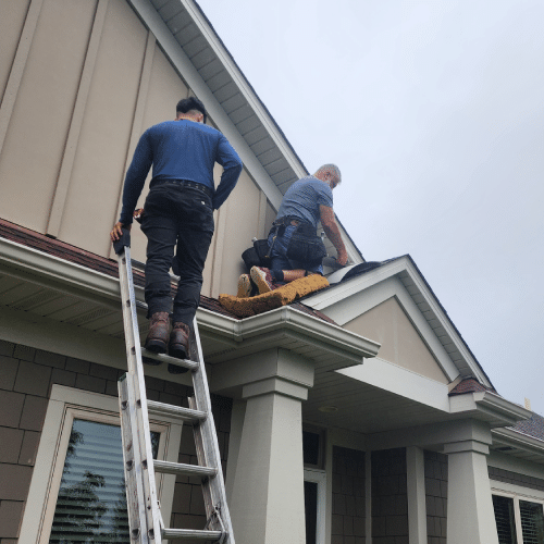 Roofing crew installing new shingles ensuring warranty-backed quality by Wright at Home Roofing & Exteriors in Minneapolis