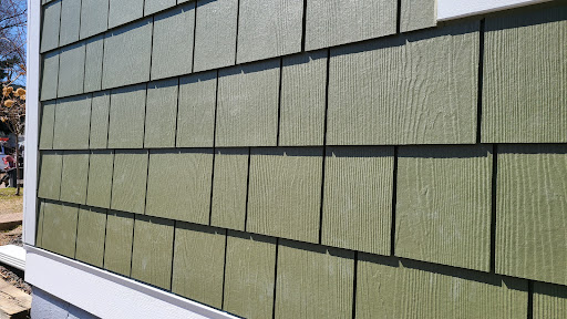 Green exterior siding installation for residential home by Wright at Home Roofing & Exteriors in Brooklyn Center