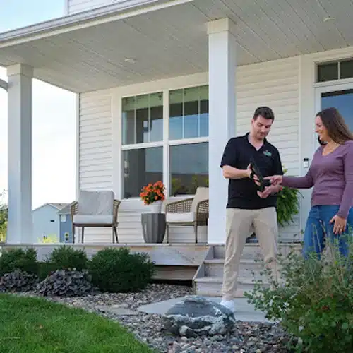 Roofing contractor discussing roof inspection schedule with homeowners by Wright at Home Roofing & Exteriors in MN