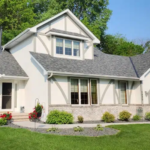 Home remodel with fresh roofing and light exterior finish by Wright at Home Roofing & Exteriors