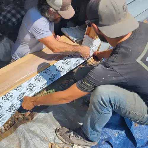Window installers applying waterproof flashing during replacement window installation by Wright at Home Roofing & Exteriors in Minneapolis