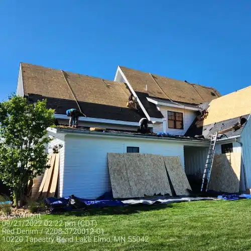Crew installing new roof during replacement project by Wright at Home Roofing & Exteriors