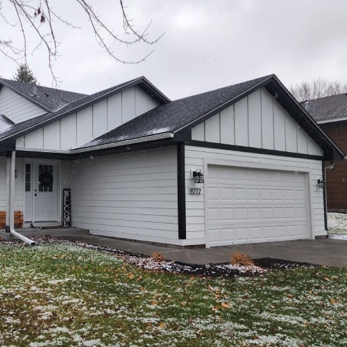 White suburban home with fresh siding installation by Wright at Home Roofing & Exteriors in Minneapolis