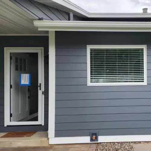 Front home entry with new window replacement and James Hardie siding by Wright at Home Roofing & Exteriors in Blaine MN