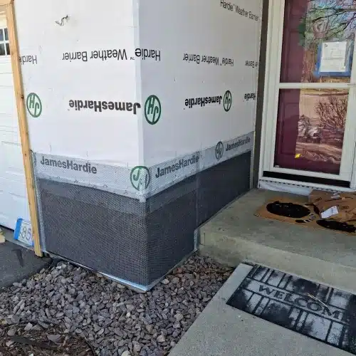 Entry corner prep with HardieWrap and stone veneer lath before siding install for home exterior restoration in Plymouth, MN by Wright at Home Roofing & Exteriors in Plymouth, MN