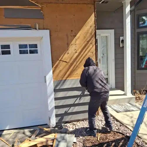 Crew installing James Hardie lap siding after storm damage repairs during home exterior restoration in Plymouth, MN by Wright at Home Roofing & Exteriors in Plymouth, MN
