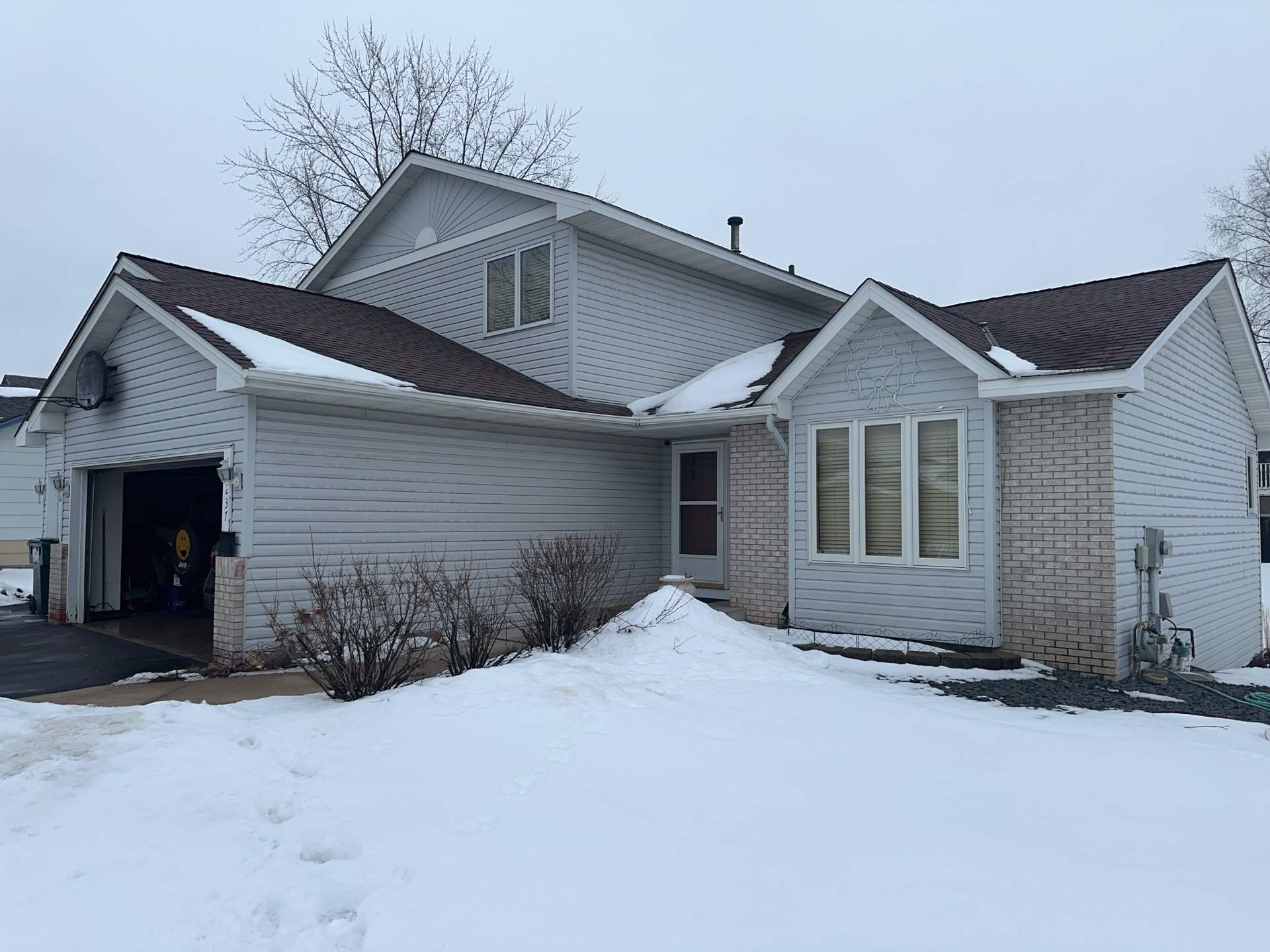 Light gray two‑story home exterior remodel in Blaine MN by Wright at Home Roofing & Exteriors